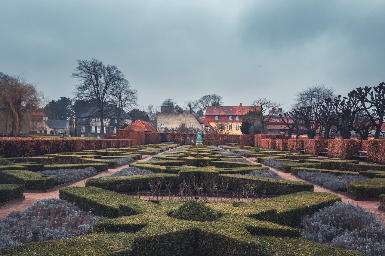 services-03 Explore the symmetrical hedges and historic architecture of a Copenhagen park.